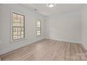 Bright and airy bedroom featuring hardwood floors and natural light from large windows at 10508 Kristens Mare Dr, Charlotte, NC 28277