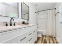 Modern bathroom with double vanity, sleek black fixtures, and a shower-tub combination at 117 Autumn Woods Dr, Kings Mountain, NC 28086