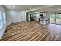 Open-concept living area featuring wood floors, white walls, and a modern kitchen with stainless steel appliances at 117 Autumn Woods Dr, Kings Mountain, NC 28086