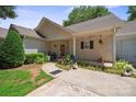 Charming single-story home with a covered porch, landscaped flower beds, and inviting curb appeal at 119 Ashwood Ln, Mooresville, NC 28117
