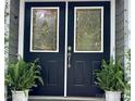 Close up of the front door, featuring black double doors with decorative glass panels at 1230 Somersby Ln, Matthews, NC 28105