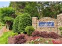 Stone community entrance sign surrounded by greenery at 12904 Windy Lea Ln, Huntersville, NC 28078