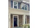 Exterior view of home featuring stone facade, covered porch, balcony, and visible house number at 12904 Windy Lea Ln, Huntersville, NC 28078