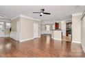 Open living room with hardwood floors, fan and views of the kitchen and dining area at 13407 Morgan Lee Ave, Charlotte, NC 28213