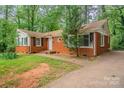 A charming brick home with black shutters and a well-kept lawn at 1401 Hillwood Ct, Charlotte, NC 28210