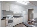 Functional kitchen with white cabinets, laminate countertops, and essential appliances at 1401 Hillwood Ct, Charlotte, NC 28210