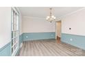 Bright dining room with modern light fixture, fresh paint, and updated flooring at 14027 Hackamore Dr, Matthews, NC 28105