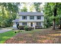 Traditional two-story home featuring a cozy front porch and well-maintained landscaping at 14027 Hackamore Dr, Matthews, NC 28105