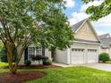 Charming home featuring a two-car garage and a well-manicured lawn with beautiful landscaping at 147 Wren Hill Dr, Mooresville, NC 28115