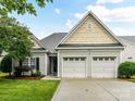 Charming home featuring a two-car garage and a well-manicured lawn with beautiful landscaping at 147 Wren Hill Dr, Mooresville, NC 28115