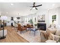 Bright, open-concept living space featuring a fireplace, leather armchairs, and seamless flow into the kitchen at 1490 White Hall Pl, Gastonia, NC 28056