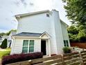 View of charming two-story home featuring low shrubs and proximity to nearby foliage and wooden fence at 1519 Briar Creek Rd # B, Charlotte, NC 28205