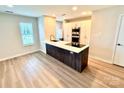 Bright kitchen features a modern island with sleek countertops, stainless steel appliances, and ample natural light at 1519 Briar Creek Rd # B, Charlotte, NC 28205