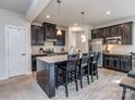Stylish kitchen with a large island, stainless steel appliances, and sleek black cabinetry at 1607 Tundra Ln, Denver, NC 28037