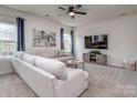 Cozy living room with a plush sectional sofa, modern decor, and ample natural light at 1607 Tundra Ln, Denver, NC 28037