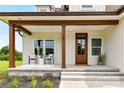 Inviting front porch with stylish seating, complemented by a well-maintained garden and elegant entrance at 181 Lone Pine Rd, Statesville, NC 28625
