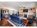 Comfortable living room with hardwood floors, a fireplace, built-in shelves and an open floor plan at 1858 Brevard Place Rd, Iron Station, NC 28080