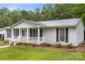 Well-maintained single-story house with a covered front porch, metal roof and classic curb appeal at 1983 Burkin Rd, McConnells, SC 29726
