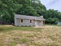 Beautiful single-story home featuring light green siding, wooden shutters, and a well-maintained lawn at 2070 Stirewalt Rd, China Grove, NC 28023