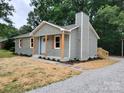 Inviting single-story house with light green siding, complemented by a fresh lawn and landscape at 2070 Stirewalt Rd, China Grove, NC 28023