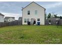 Spacious backyard with a wood fence, offering privacy for outdoor activities at 211 Hidden Lakes Rd, Statesville, NC 28677