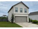 Two-story home featuring an attached two-car garage and well-manicured lawn at 211 Hidden Lakes Rd, Statesville, NC 28677