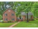 Charming brick home featuring a well-manicured lawn and inviting front porch at 2301 Seth Thomas Rd, Charlotte, NC 28210
