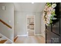 Welcoming foyer with tile flooring, staircase, and a glimpse into the kitchen at 2301 Seth Thomas Rd, Charlotte, NC 28210