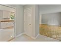 Hallway featuring tile floors, views into the kitchen and hardwood floors in the living spaces at 2301 Seth Thomas Rd, Charlotte, NC 28210