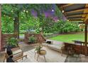 Brick patio with stylish seating and string lights offers a cozy outdoor experience at 2301 Seth Thomas Rd, Charlotte, NC 28210