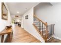 Inviting hallway with wood floors, staircase, and decor with a view into the living and dining areas at 2317 Trollinger Dr, Catawba, NC 28609