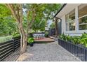 Backyard deck with a cozy dining set, perfect for outdoor entertaining, surrounded by trees and greenery at 2424 Cumberland Ave, Charlotte, NC 28203