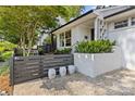Charming front yard featuring decorative stone, modern fencing, and lush landscaping, enhancing curb appeal at 2424 Cumberland Ave, Charlotte, NC 28203