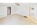 Bright living room featuring neutral walls and carpet, trimmed doorways, and a ceiling fan at 271 Nc 16 N Hwy, Taylorsville, NC 28681