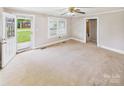 Neutral living room featuring a ceiling fan and a glass door with a view of the outdoors at 271 Nc 16 N Hwy, Taylorsville, NC 28681