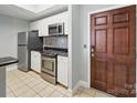 Well-lit kitchen featuring stainless steel appliances, white cabinets, and granite countertops at 300 W 5Th St # 339, Charlotte, NC 28202