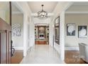 Inviting foyer boasting marble floors, elegant lighting, and views of the living room at 3032 Kings Manor Dr, Matthews, NC 28104