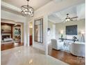 Hallway leading into an office area; hardwood flooring with abundant natural light at 3032 Kings Manor Dr, Matthews, NC 28104