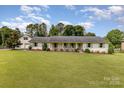 Charming one-story home with brick exterior, lush lawn, and a separate garage at 309 Ogden Dr, Gastonia, NC 28056