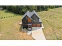 Overhead shot of modern home, highlighting its sleek design, large driveway, and lush surrounding greenery at 309 Sain Rd, Statesville, NC 28625