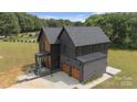 Aerial view of modern home showcases its unique roofline, attached garage, and well-manicured lawn at 309 Sain Rd, Statesville, NC 28625
