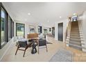 Bright living room with modern furnishings, large windows, and light wood floors at 309 Sain Rd, Statesville, NC 28625
