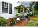 Inviting covered porch with wrought iron railings, adorned with plants and stylish decor at 441 Jackson St, Rock Hill, SC 29730