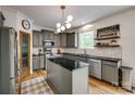 A modern kitchen with dark cabinets, stainless steel appliances, black granite countertops, and a central island at 4712 Amberside Dr, Rock Hill, SC 29732
