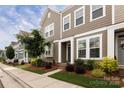 Attractive townhome exterior with lush landscaping and a welcoming sidewalk at 512 Morrows Turnout Way, Pineville, NC 28134