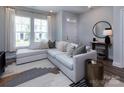 Cozy living room with a comfortable sectional sofa and bright, natural light at 512 Morrows Turnout Way, Pineville, NC 28134