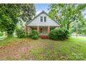 Charming two-story home with brick-columned front porch and lush landscaping at 520 Eastwood Park Cir, Albemarle, NC 28001