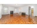 Bright living room with parquet floors, fireplace, and staircase at 520 Eastwood Park Cir, Albemarle, NC 28001