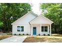 Beautifully renovated one-story home with a bright blue front door and neatly landscaped front yard at 617 English St, Monroe, NC 28110