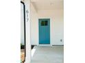 Close-up of a bright blue front door with glass panel, complemented by white siding and modern address numbers at 617 English St, Monroe, NC 28110